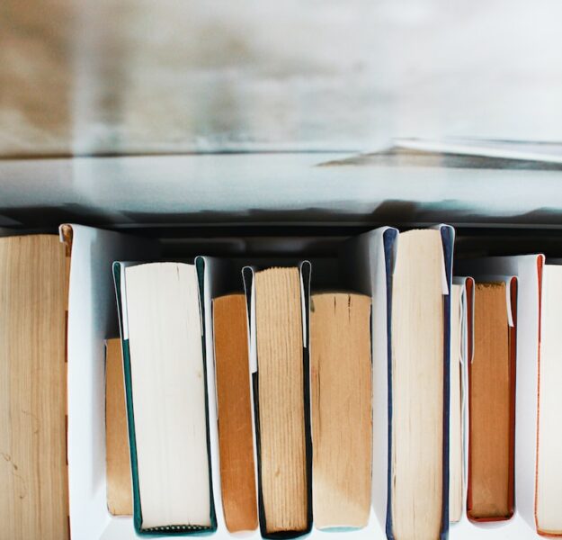 low angle photography of pile of books